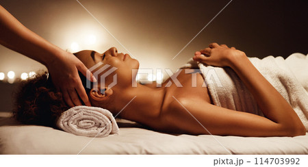 Woman enjoying face massage and aroma therapy, relaxing in spa salon Woman enjoying face massage and aroma therapy, relaxing in spa salon 114703992
