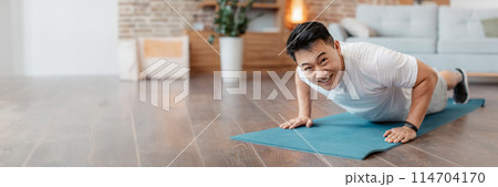 Strong asian mature man making strength workout, standing in plank pose or doing push ups at home on yoga mat. Happy guy training his body, leading active lifestyle, copy space Strong asian mature man making strength workout, standing in plank pose or doing push ups at home on yoga mat. Happy guy training his body, leading active lifestyle, copy space 114704170