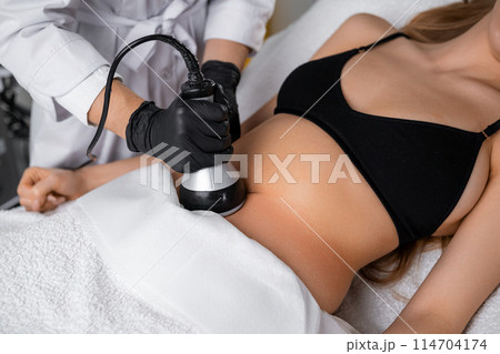Vacuum procedure after ultrasound cavitation of the abdomen for young woman 114704174