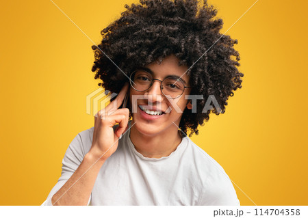 Mobile connection ad. Awesome black guy talking on cellphone, orange background 114704358