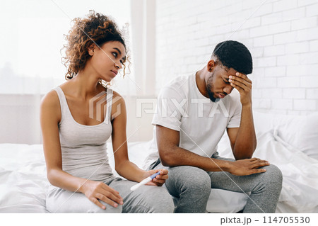 African american young couple faces disappointment with a negative pregnancy test result in a domestic setting African american young couple faces disappointment with a negative pregnancy test result in a domestic setting 114705530