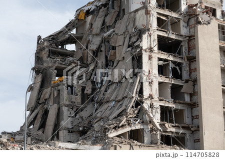 Collapsed building ruins after a destructive disaster with debris 114705828