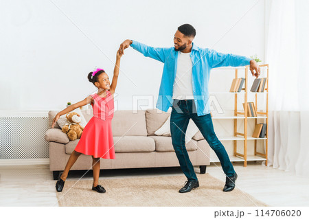 African-american father dancing with little daughter at home African-american father dancing with little daughter at home 114706020