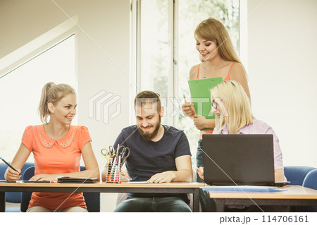 Students and teacher tutor in classroom Students and teacher tutor in classroom 114706161