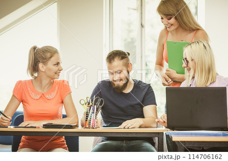 Students and teacher tutor in classroom Students and teacher tutor in classroom 114706162