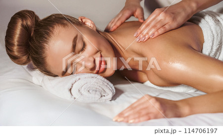 Total Relaxation. Woman Getting Back Massage In Spa Center With Orchids Nearby 114706197
