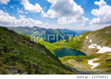 fagaras mountains landscape of carpathian range in summer. scenery with glacier lake capra between hills on a sunny day. popular travel destination of romania, europe 114708011