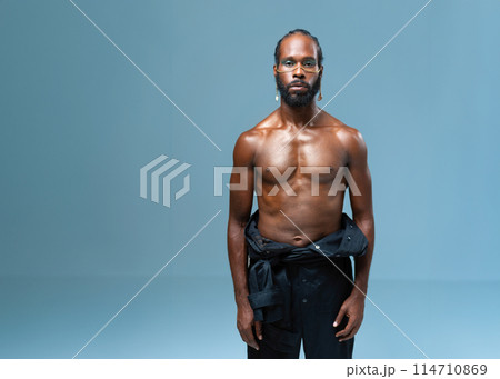 Shirtless muscular black gay man with light makeup 114710869