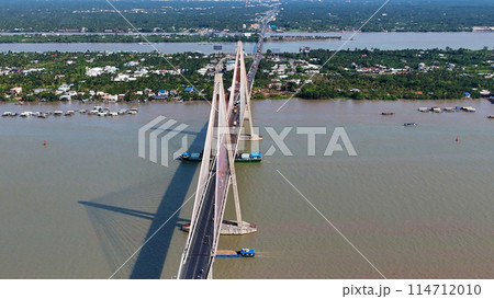 Aerial view of Rach Mieu Bridge cross Tien river, link Tien Giang with Ben Tre, cable stayed bridge at Mekong Delta, boat traffic on water, vehicle on road Aerial view of Rach Mieu Bridge cross Tien river, link Tien Giang with Ben Tre, cable stayed bridge at Mekong Delta, boat traffic on water, vehicle on road 114712010