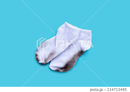 Dirty white socks on blue background. 114713495