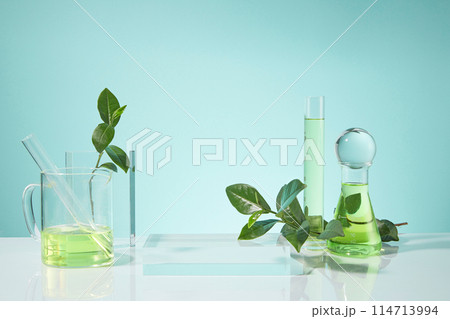 Photo was taken from front view on baby blue background with gradient effect, an empty platform placed in center with some researching tools and green tea decorated around, presentation space Photo was taken from front view on baby blue background with gradient effect, an empty platform placed in center with some researching tools and green tea decorated around, presentation space 114713994