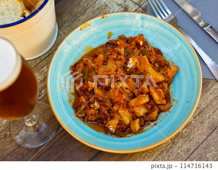 Cod stew with vegetables peppers, tomatoes, garlic and onions close-up in bowl on the table Cod stew with vegetables peppers, tomatoes, garlic and onions close-up in bowl on the table 114716143