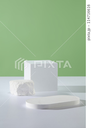 Several white podiums in geometric shapes are featured. Pastel green background. Product presentation, mockup, show cosmetic product, Podium, stage pedestal or platform Several white podiums in geometric shapes are featured. Pastel green background. Product presentation, mockup, show cosmetic product, Podium, stage pedestal or platform 114716616