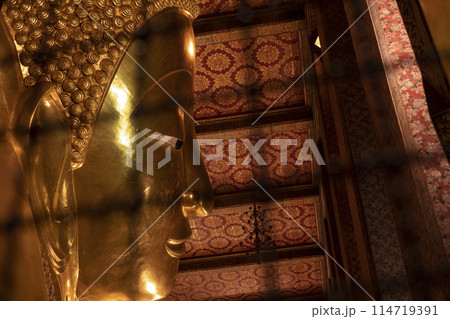 The giant reclining Buddha golden statue is seen at Wat Pho temple complex The giant reclining Buddha golden statue is seen at Wat Pho temple complex 114719391