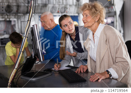 Positively minded family together solve puzzles in a quest room in form of an abandoned laboratory Positively minded family together solve puzzles in a quest room in form of an abandoned laboratory 114719564