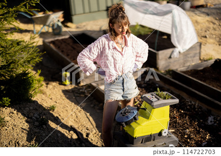 Woman works at backyard garden Woman works at backyard garden 114722703