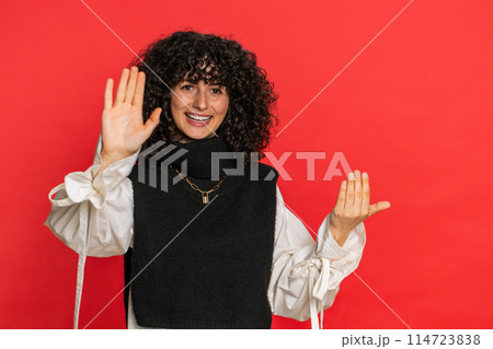 Happy woman smiling friendly waving hands gesturing hello greeting or goodbye, meeting invitation Happy woman smiling friendly waving hands gesturing hello greeting or goodbye, meeting invitation 114723838