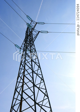 HIgh voltage transmission network silhouette over the sky HIgh voltage transmission network silhouette over the sky 114724094