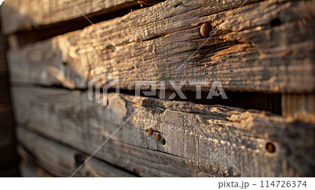 Aged wooden boards on a rural fence. 114726374