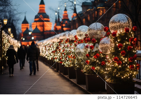 People walking down a Christmasdecorated sidewalk 114726645