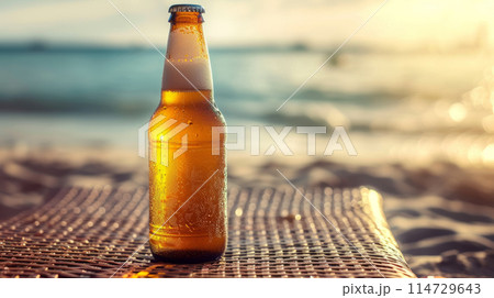 A bottle of cold beer against the background of the ocean. 114729643