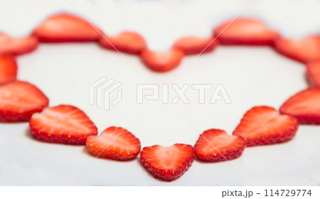 Beautiful heart symbol from chopped red juicy strawberry 114729774