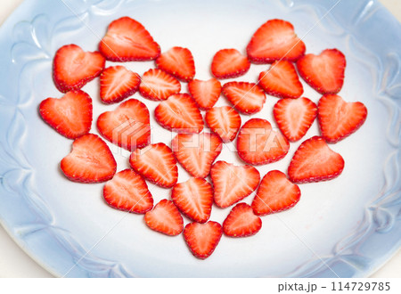 Beautiful heart symbol from chopped red juicy strawberry 114729785