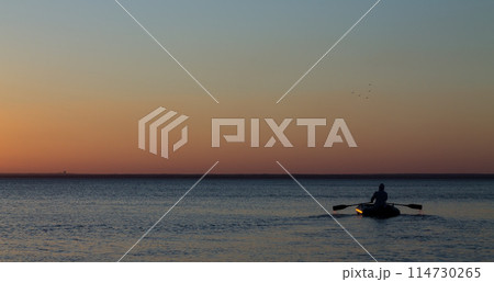 Man with the oars on the water in the sea Man with the oars on the water in the sea 114730265
