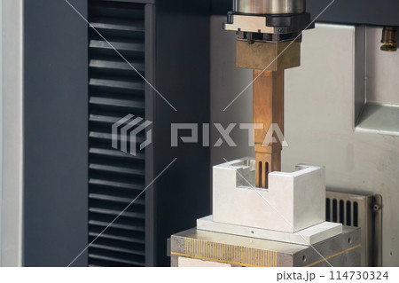 The copper electrode working on EDM machine. The copper electrode working on EDM machine. 114730324