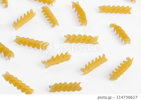 Pasta products in the form of a spiral, texture, on a white background Pasta products in the form of a spiral, texture, on a white background 114730627