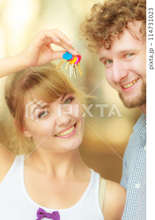 Couple showing their new house keys Couple showing their new house keys 114731023