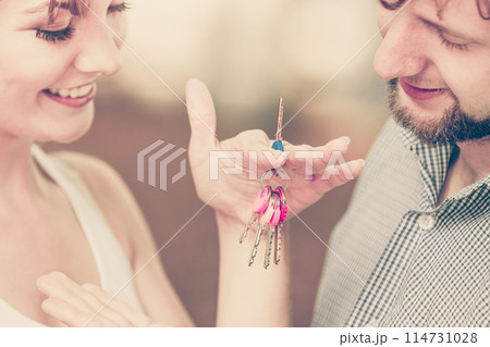 Couple showing their new house keys Couple showing their new house keys 114731028