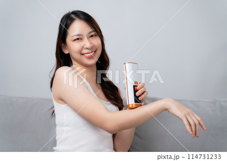 A beautiful woman is epilating and removing hair using an IPL laser hair removal epilator device. A beautiful woman is epilating and removing hair using an IPL laser hair removal epilator device. 114731233