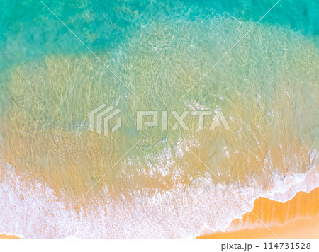 Amazing Top view sea beach landscape background,Summer sea waves crashing on sandy shore seascape background,High angle view ocean nature background Amazing Top view sea beach landscape background,Summer sea waves crashing on sandy shore seascape background,High angle view ocean nature background 114731528