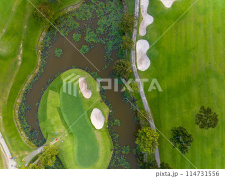 Aerial view of beautiful green golf field fairway and putting green, Top down image for sport background and travel nature background, Amazing green nature view Aerial view of beautiful green golf field fairway and putting green, Top down image for sport background and travel nature background, Amazing green nature view 114731556