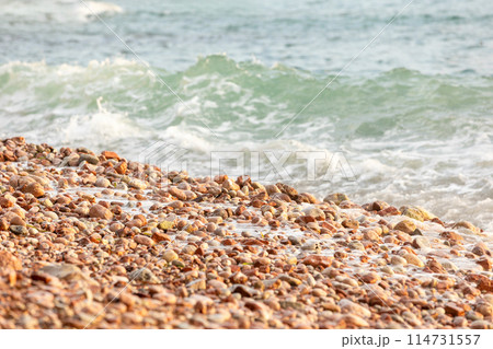 Pebble stones on the shore close up background Pebble stones on the shore close up background 114731557