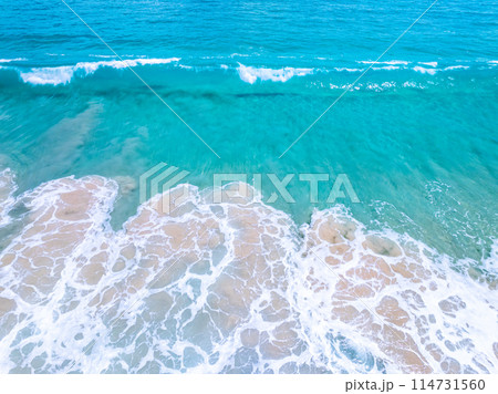 Amazing Top view sea beach landscape background,Summer sea waves crashing on sandy shore seascape background,High angle view ocean nature background 114731560