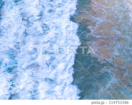 Amazing Top view sea beach landscape background,Summer sea waves crashing on sandy shore seascape background,High angle view ocean nature background 114731586