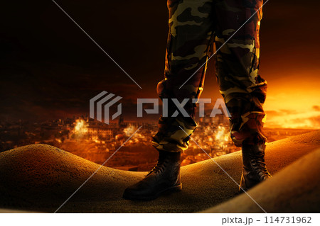 Soldier feet with military boots standing with fire and explosion 114731962