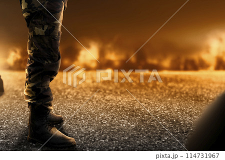 Soldier feet with military boots standing with fire and explosion 114731967