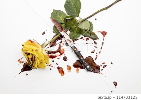 The beautiful yellow rose with knife on bloody background. The beautiful yellow rose with knife on bloody background. 114733125