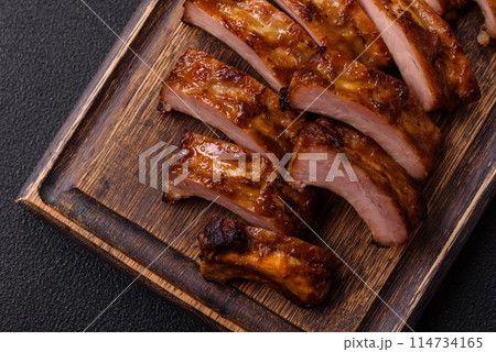 Delicious juicy grilled ribs with honey and mustard sauce Delicious juicy grilled ribs with honey and mustard sauce 114734165