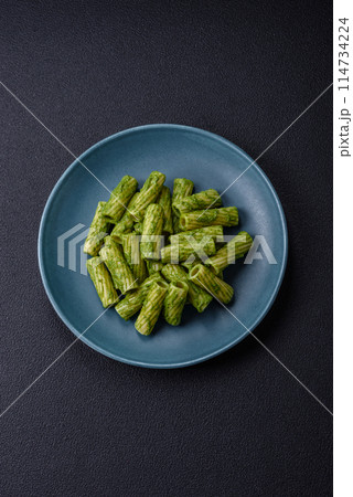 Delicious pasta with spinach sauce, olive oil and parmesan cheese 114734224