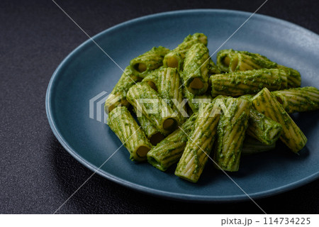 Delicious pasta with spinach sauce, olive oil and parmesan cheese Delicious pasta with spinach sauce, olive oil and parmesan cheese 114734225