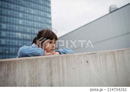 Sad girl alone in the city. Young girl spending free time alone in the city, no friends, no activity. 114734282