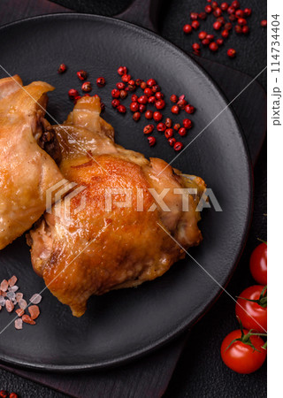 Delicious juicy chicken thighs baked on the grill with salt Delicious juicy chicken thighs baked on the grill with salt 114734404