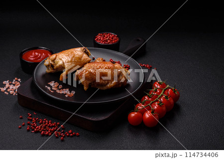 Delicious juicy chicken thighs baked on the grill with salt Delicious juicy chicken thighs baked on the grill with salt 114734406
