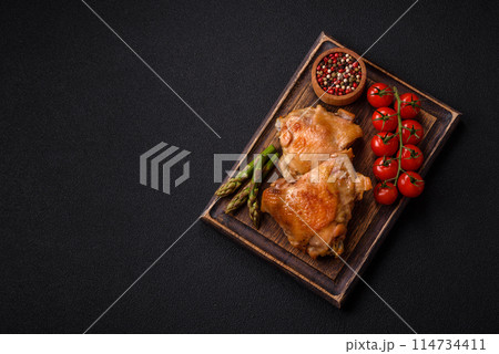 Delicious juicy chicken thighs baked on the grill with salt 114734411