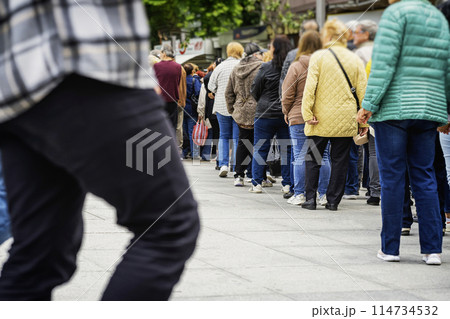 Public crowd. People queue up waiting outside 114734532