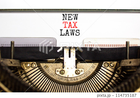New tax laws symbol. Concept words New tax laws typed on an old retro typewriter on a beautiful white paper background. Business new tax laws concept. Copy space. New tax laws symbol. Concept words New tax laws typed on an old retro typewriter on a beautiful white paper background. Business new tax laws concept. Copy space. 114735187